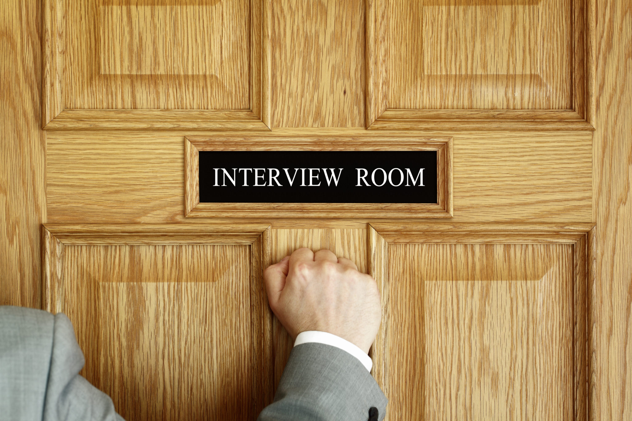 Students begin their interview sessions by knocking on the door and