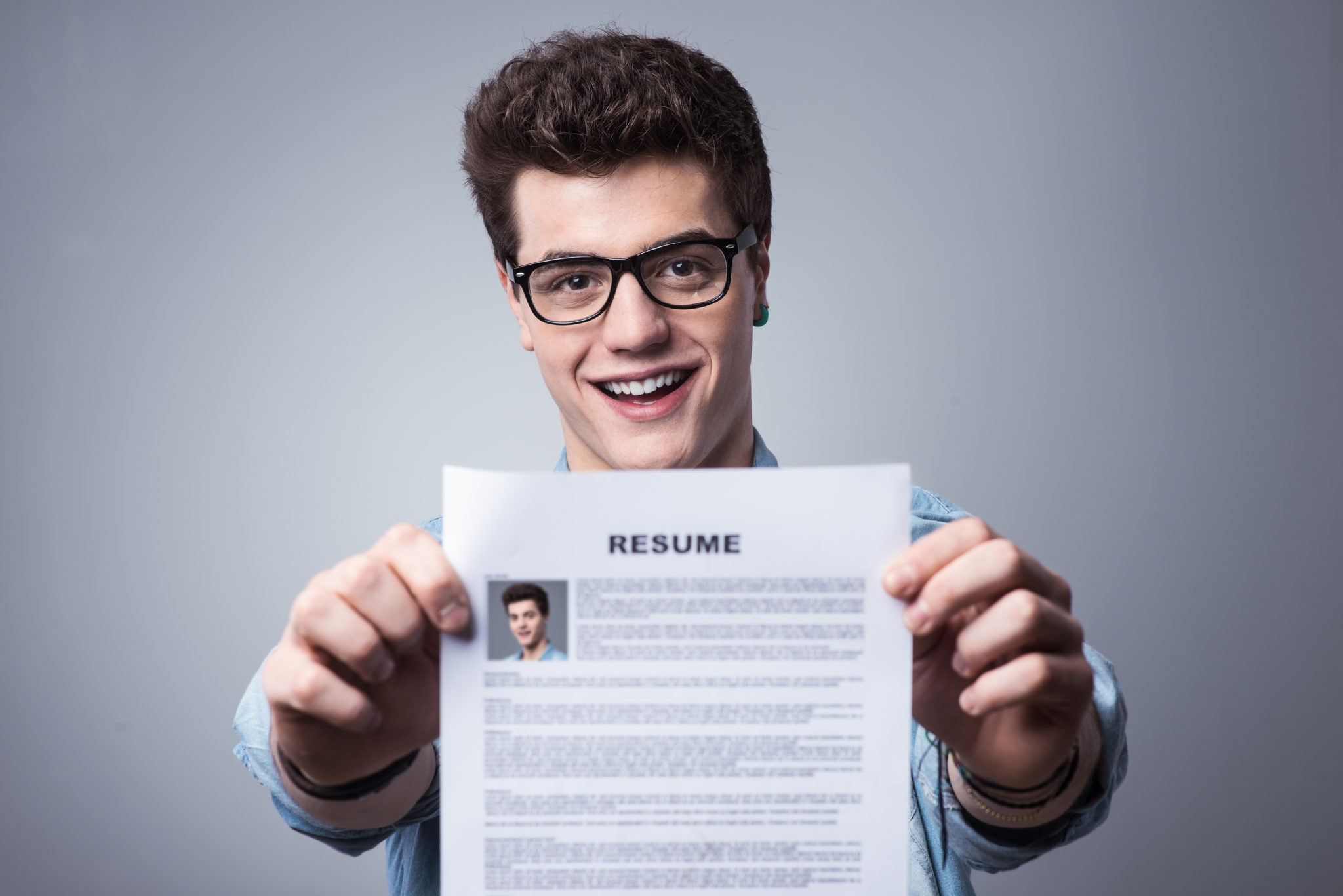 young man with resume without college degree